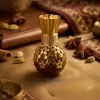 A Majestic Blend of Tradition and Luxury. Step into a world of royal aromas with our Royal Golden Glow Attar. Housed in an exquisitely designed chocolate-brown and golden-filigree bottle, this 20ml premium attar is a tribute to India's rich olfactory heritage. Its deep, captivating fragrance is designed for those who appreciate the finer things in life, making it a perfect companion for both spiritual gatherings and special occasions. What Makes It Extraordinary? Pure & Alcohol-Free: A high-quality oil-based concentrate that is kind to your skin and stays true to its scent for hours. Intricate Designer Bottle: The ornate golden bottle is a piece of art itself, making it a stunning addition to your collection or an unforgettable gift. Rich, Long-Lasting Scent: Carefully blended to provide a lasting aroma that evolves beautifully throughout the day. Spiritual & Personal Use: Ideal for applying during meditation to enhance focus, or as a signature personal fragrance.