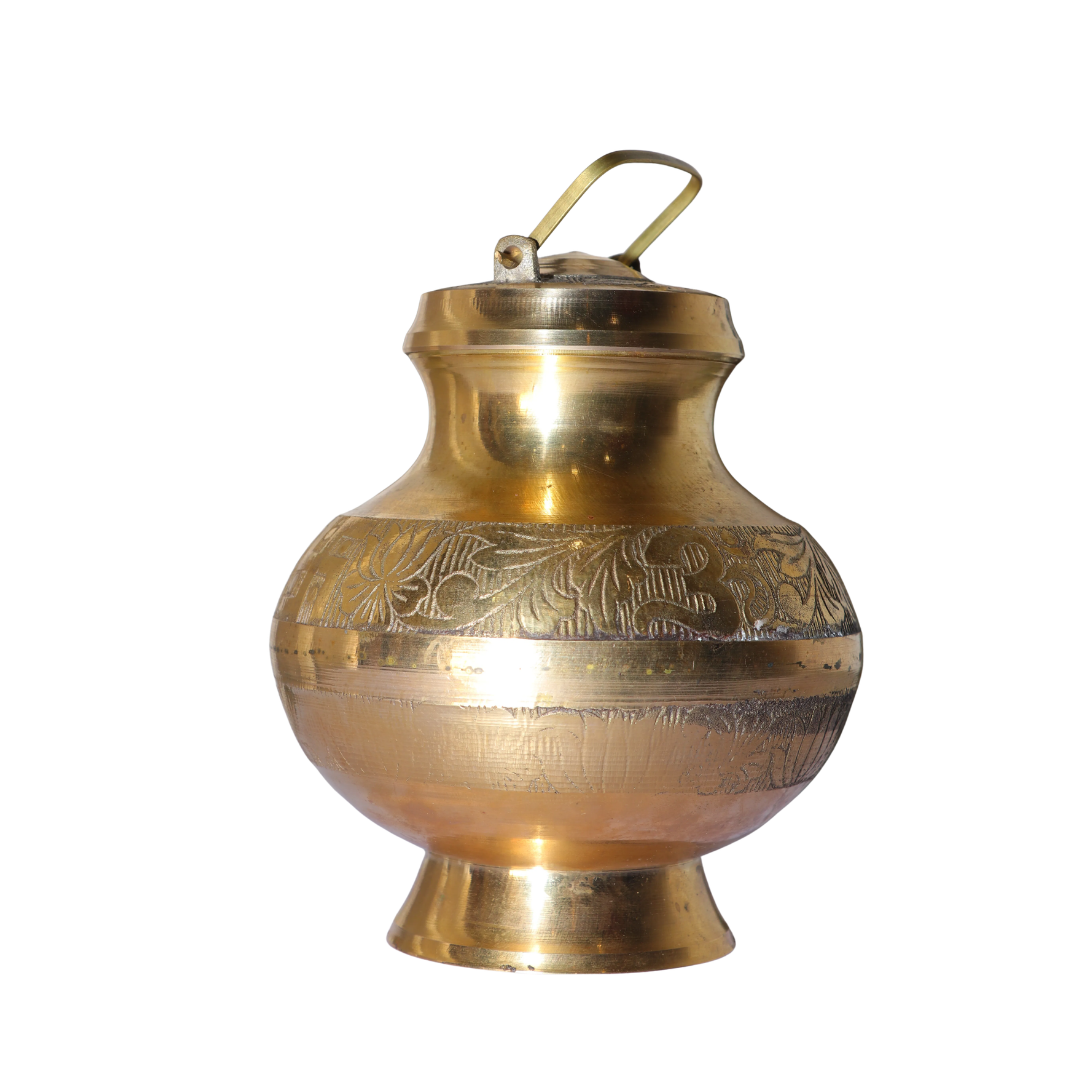 A Divine Masterpiece for Your Home Mandir. Bring the timeless purity of the Ganges into your living space with our Heritage Brass Gangajali. This is not just a vessel; it is a sacred experience. Handcrafted from high-grade pure brass, this Gangajali features intricate engravings of the sacred 'Om' and Lotus flower, symbolizing peace, purity, and spiritual awakening. The Ultimate Blessing: To honor the sanctity of your devotion, each Gangajali comes pre-filled with 1 Litre of 100% Pure Ganga Jal, sourced directly from the holy banks of Har-Ki-Pauri, Haridwar. Product Highlights: Artisan Craftsmanship: Beautifully embossed with traditional motifs that reflect India’s rich spiritual heritage. Pure & Sealed: The 1 litre of Ganga Jal is collected with utmost care and sealed within the brass vessel to ensure it reaches you in its holiest form. Antique Gold Finish: Made from heavy-duty brass that provides a lasting golden glow, making it a centerpiece for any puja altar. Leak-Proof Design: Comes with a secure, sturdy handle and a well-fitted lid for safe handling and storage.